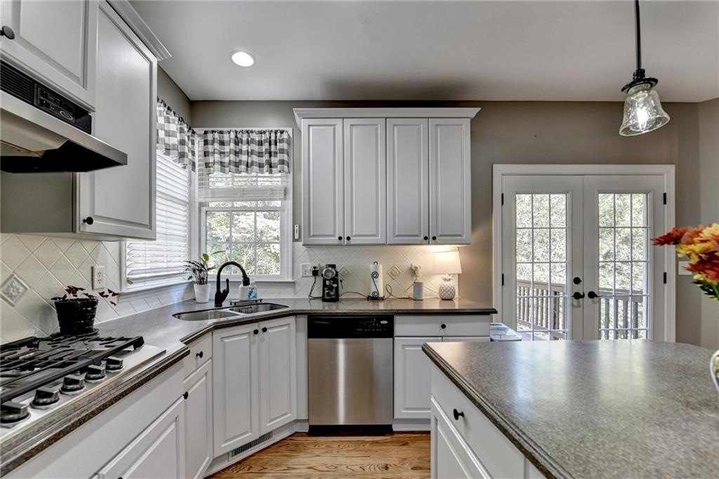1973 Hamilton Mill Parkway Dacula, GA 30019 - Photo 33 of 105 a kitchen with stainless steel appliances granite countertop a sink stove and cabinets