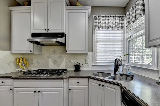 a spacious bathroom with a granite countertop tub sink and mirror