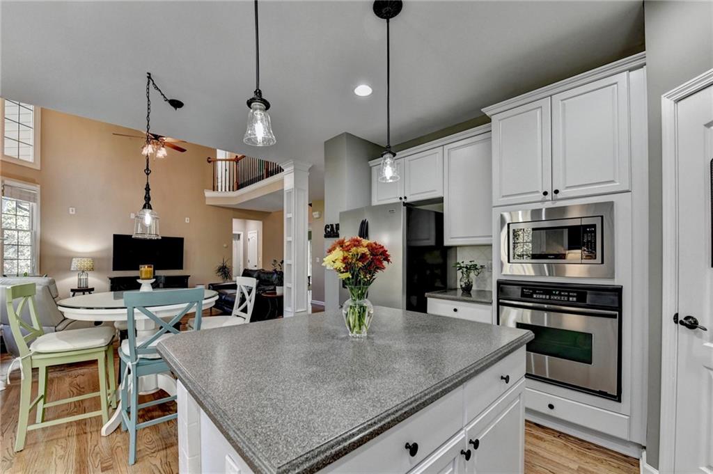 1973 Hamilton Mill Parkway Dacula, GA 30019 - Photo 35 of 105 a kitchen with stainless steel appliances granite countertop a stove refrigerator and a sink