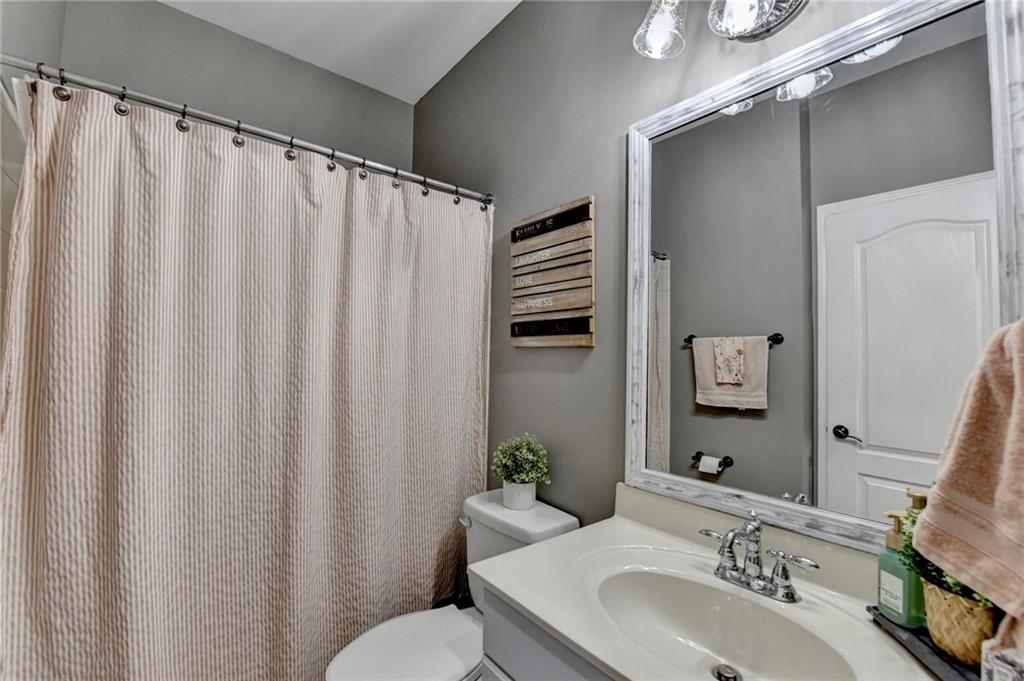1973 Hamilton Mill Parkway Dacula, GA 30019 - Photo 38 of 105 a bathroom with a sink and a mirror
