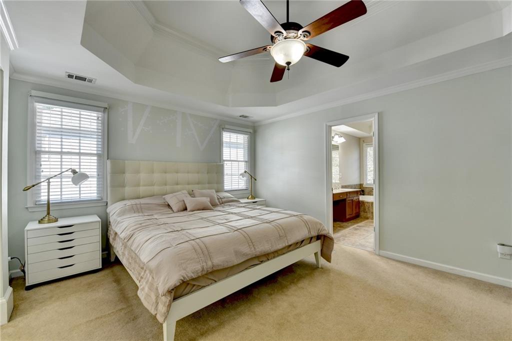 1973 Hamilton Mill Parkway Dacula, GA 30019 - Photo 46 of 105 a bedroom with a bed and a chandelier