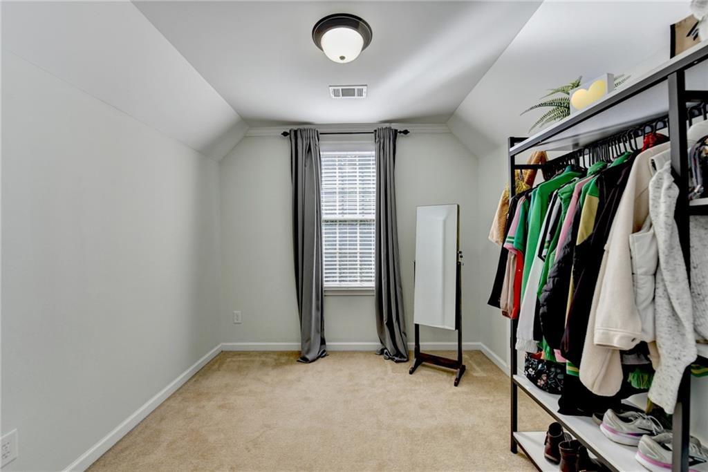 1973 Hamilton Mill Parkway Dacula, GA 30019 - Photo 48 of 105 a view of walk in closet with clothes and shoes