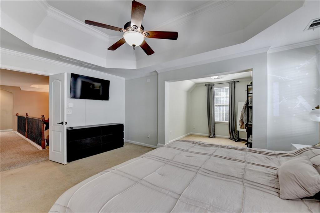 1973 Hamilton Mill Parkway Dacula, GA 30019 - Photo 49 of 105 a bedroom with a bed and a flat tv screen