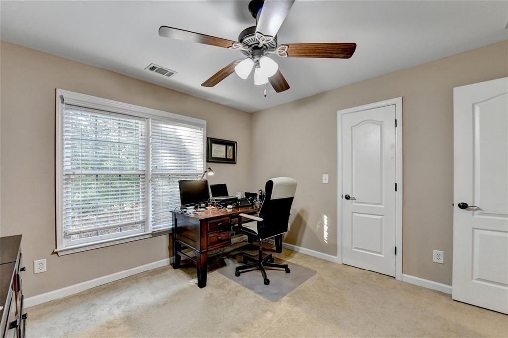 1973 Hamilton Mill Parkway Dacula, GA 30019 - Photo 56 of 105 a workspace with chandelier fan and windows