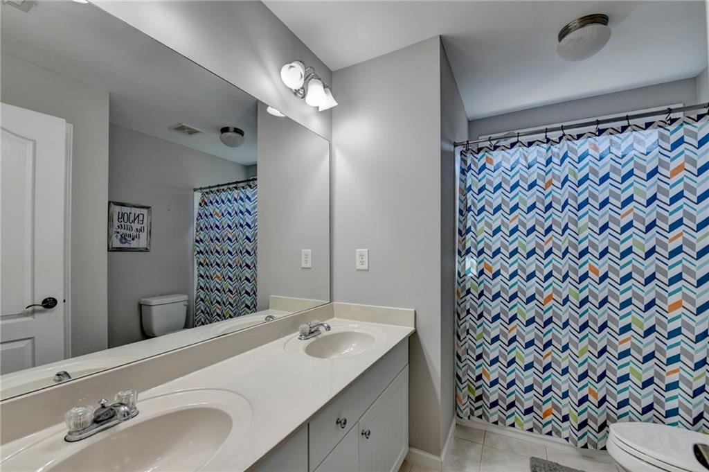 1973 Hamilton Mill Parkway Dacula, GA 30019 - Photo 63 of 105 a bathroom with a sink and a mirror