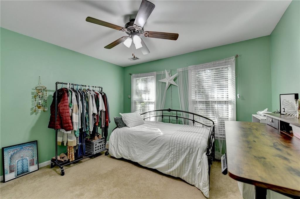 1973 Hamilton Mill Parkway Dacula, GA 30019 - Photo 64 of 105 a bedroom with a bed and a walk in closet