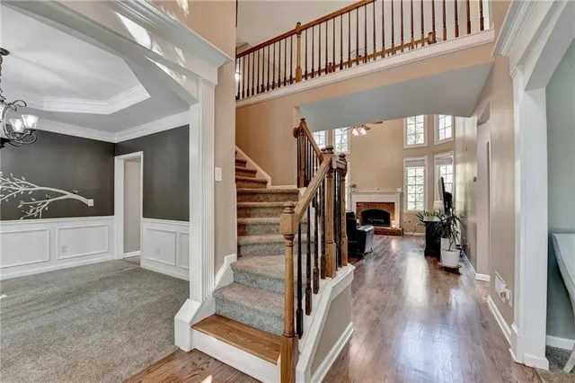 a living room with furniture fireplace and wooden floor