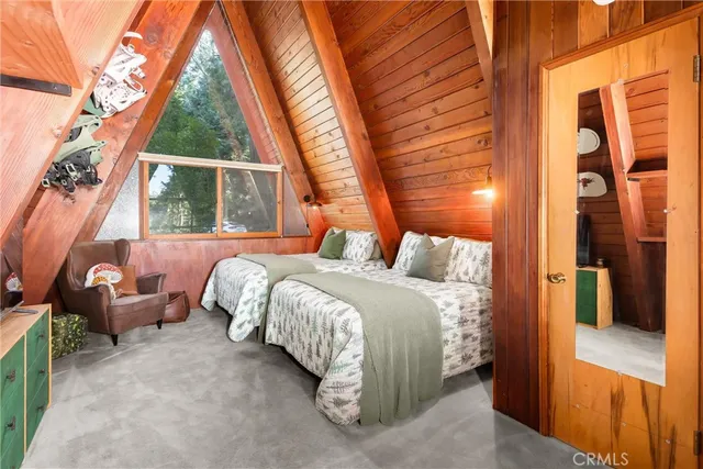 a spacious bedroom with a bed and a large window