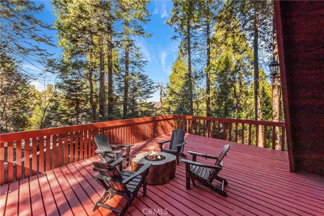 a balcony with wooden floor bench and wooden fence