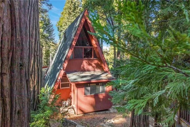 a backyard of a house with a table and chairs