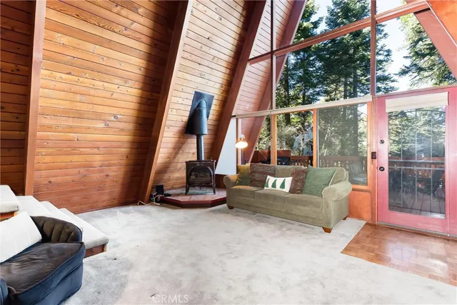 a living room with couch and large windows