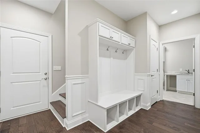 a view of kitchen with wooden floor and electronic appliances