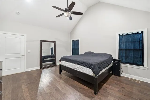 a spacious bedroom with a bed and a cabinets