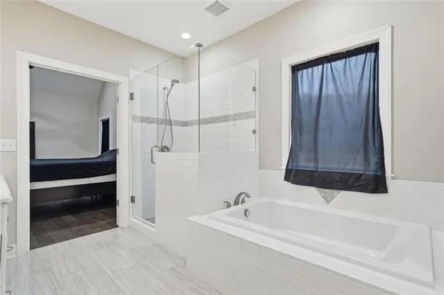 a bathroom with a bathtub and a shower