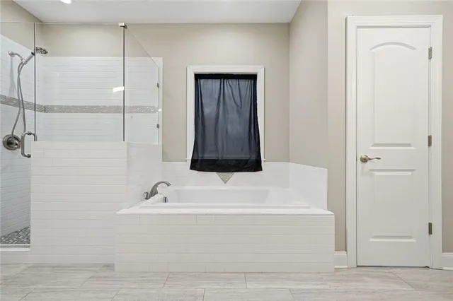 a bathroom with a bathtub and a shower