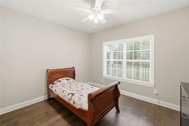a bed sitting in a bedroom next to a window