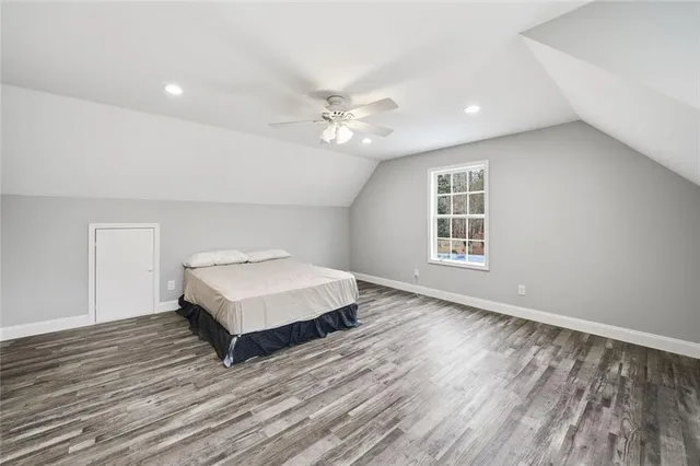 a view of a livingroom with a ceiling fan and wooden floor
