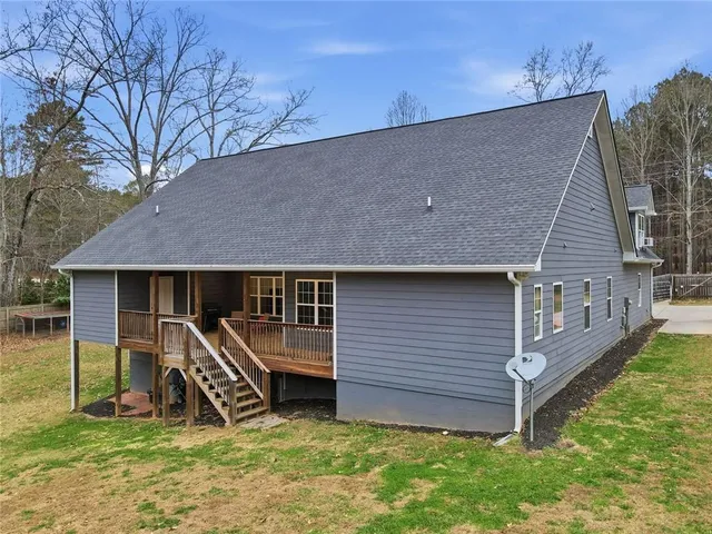 a view of a house with a yard and sitting area
