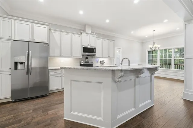 a kitchen with stainless steel appliances granite countertop a refrigerator sink and cabinets