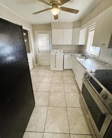 a kitchen with a sink a stove and a refrigerator