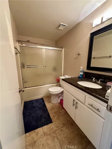 a bathroom with a bathtub shower sink vanity and toilet