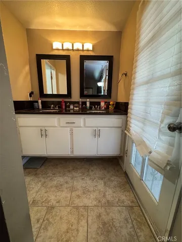 a bathroom with a sink a mirror and a bathtub