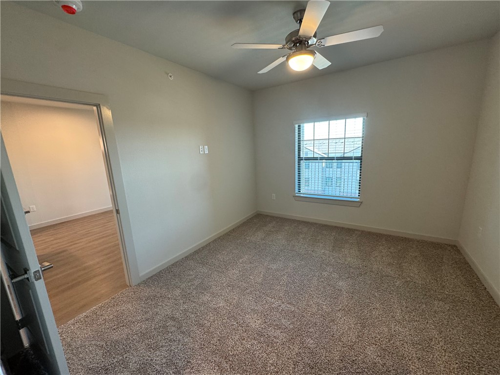 6000 Jones Road, Unit 4202 Bryan, TX 77807 - Photo 13 of 20 an empty room with windows and fan