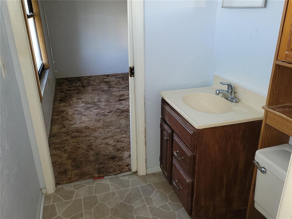 653 Atlas Avenue Northeast Palm Bay, FL 32905 - Photo 12 of 24 a bathroom with a sink a vanity and a mirror
