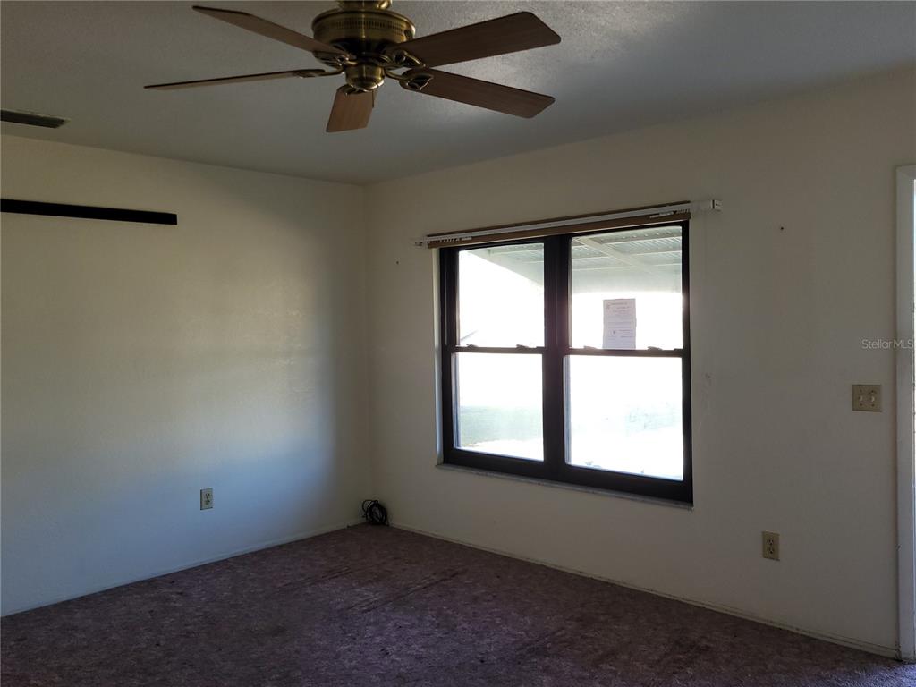 653 Atlas Avenue Northeast Palm Bay, FL 32905 - Photo 14 of 24 an empty room with a window