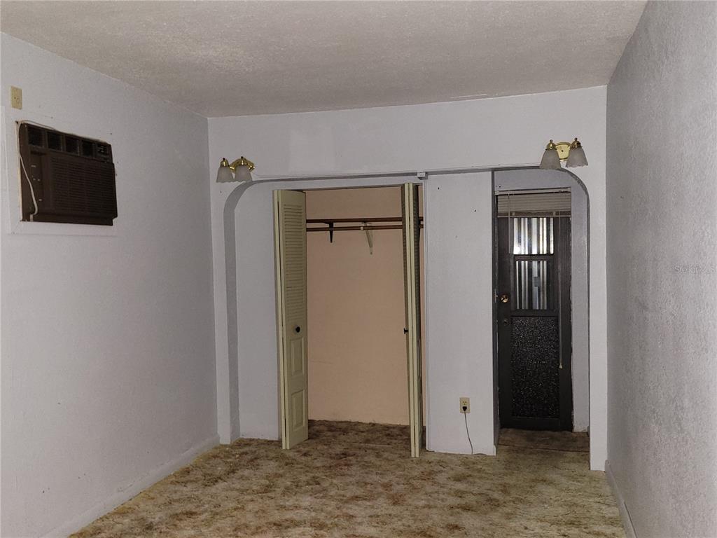 653 Atlas Avenue Northeast Palm Bay, FL 32905 - Photo 18 of 24 a view of an empty room with wooden floor and closet