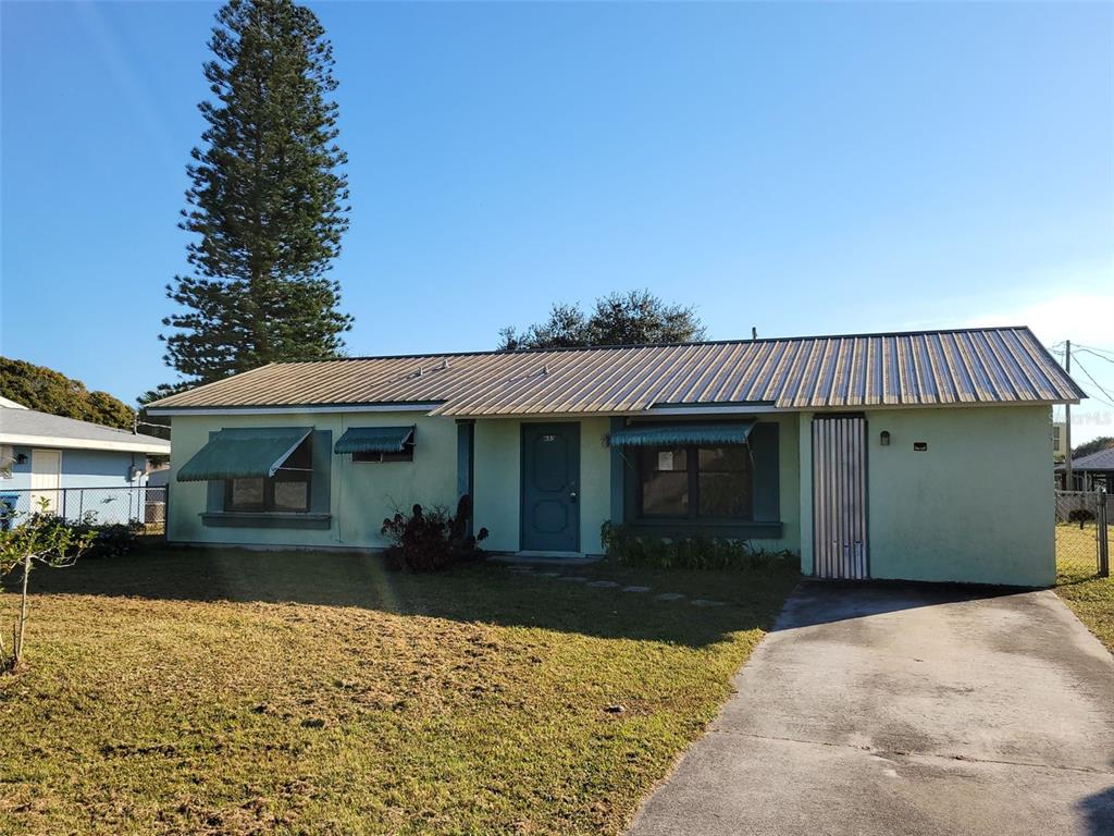 653 Atlas Avenue Northeast Palm Bay, FL 32905 - Photo 2 of 24 a front view of a house with a yard