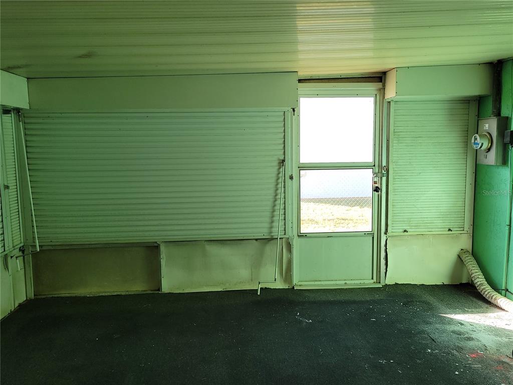 653 Atlas Avenue Northeast Palm Bay, FL 32905 - Photo 22 of 24 a view of an empty room with a fireplace and a window