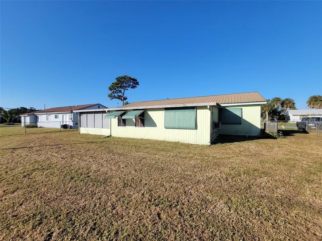 653 Atlas Avenue Northeast Palm Bay, FL 32905 - Photo 4 of 24 a front view of a house with a yard