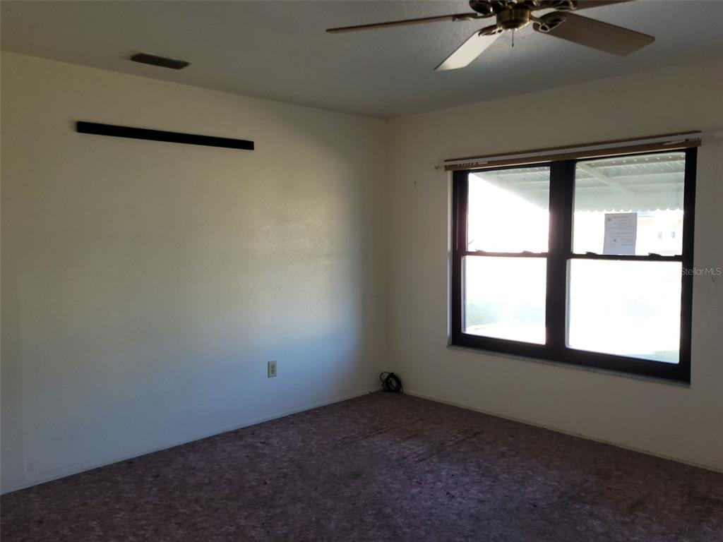 653 Atlas Avenue Northeast Palm Bay, FL 32905 - Photo 5 of 24 an empty room with a window