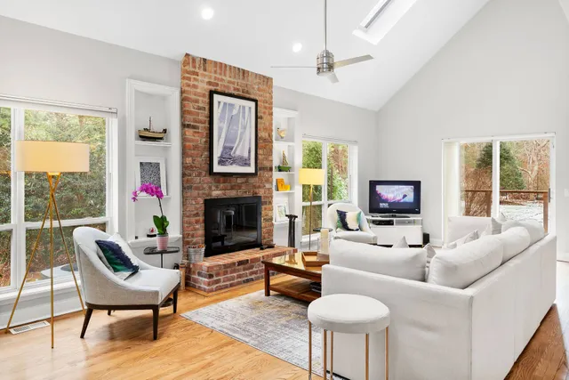 a living room with furniture a fireplace and a flat screen tv