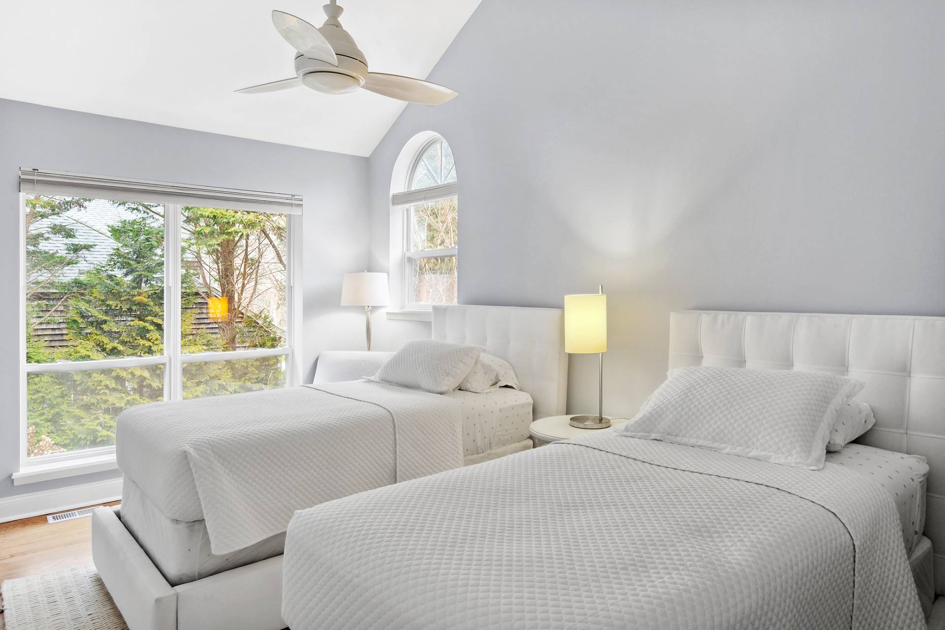 15 East Gate Road Wainscott, NY 11975 - Photo 7 of 9 a bedroom with two beds and a large window