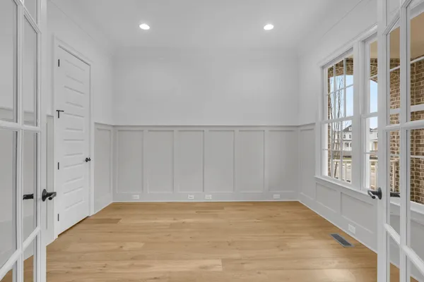 a view of a kitchen with wooden floor and windows