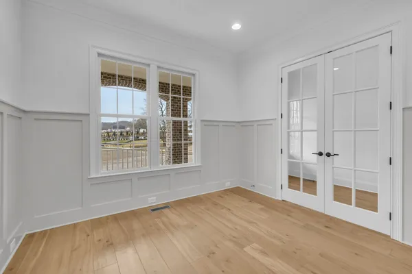 a view of a room with window wooden floor and a chandelier