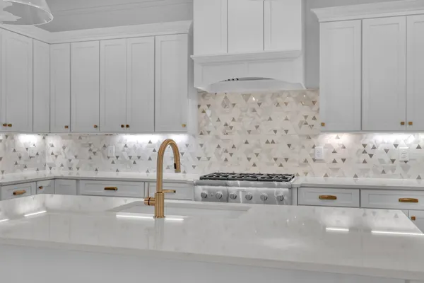 a spacious bathroom with a double vanity sink a two mirror a window and a bathtub