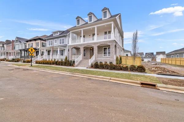 a front view of residential houses with yard
