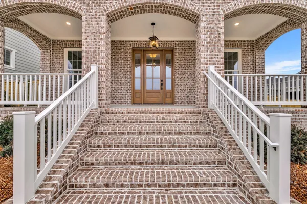 a view of a hallway with wooden floor and closet area
