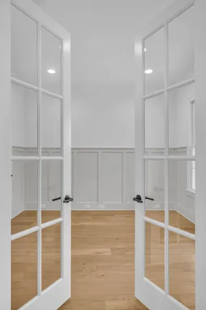 an empty room with wooden floor and closet