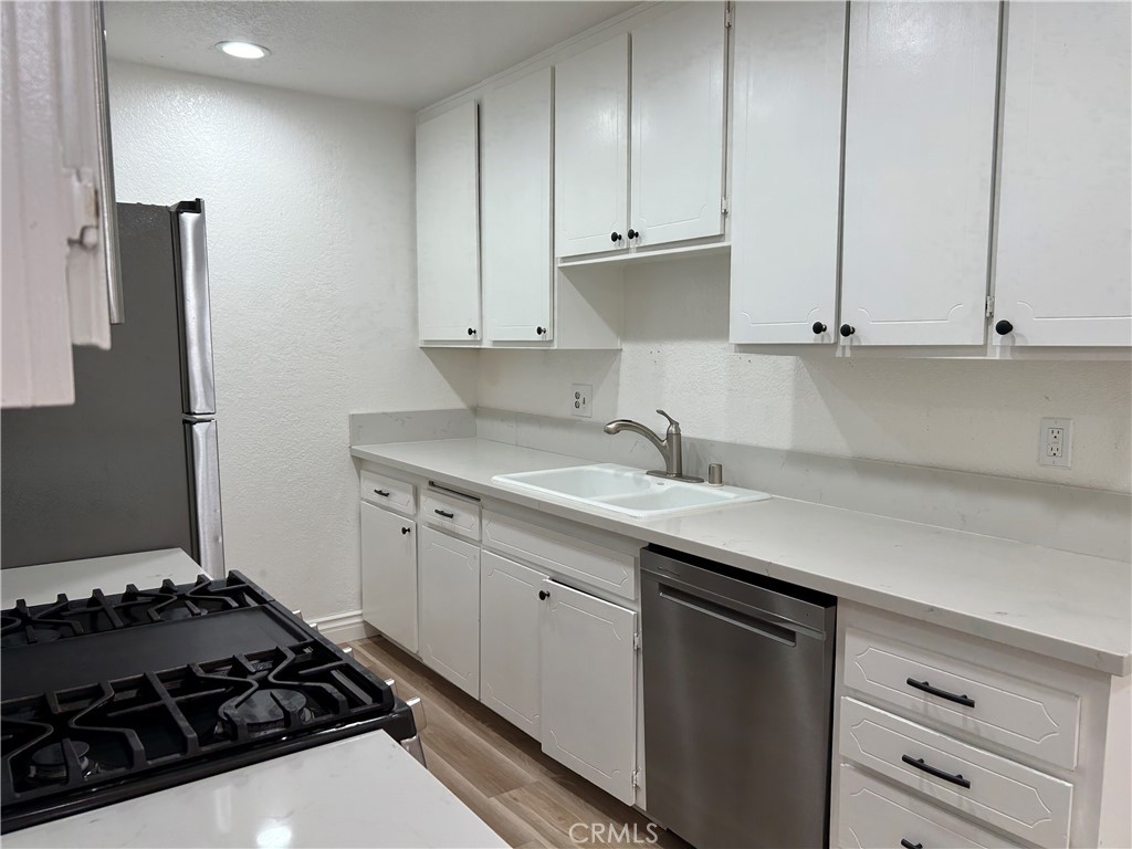 511 D Street Upland, CA 91786 - Photo 11 of 23 a kitchen with stainless steel appliances a stove and a refrigerator