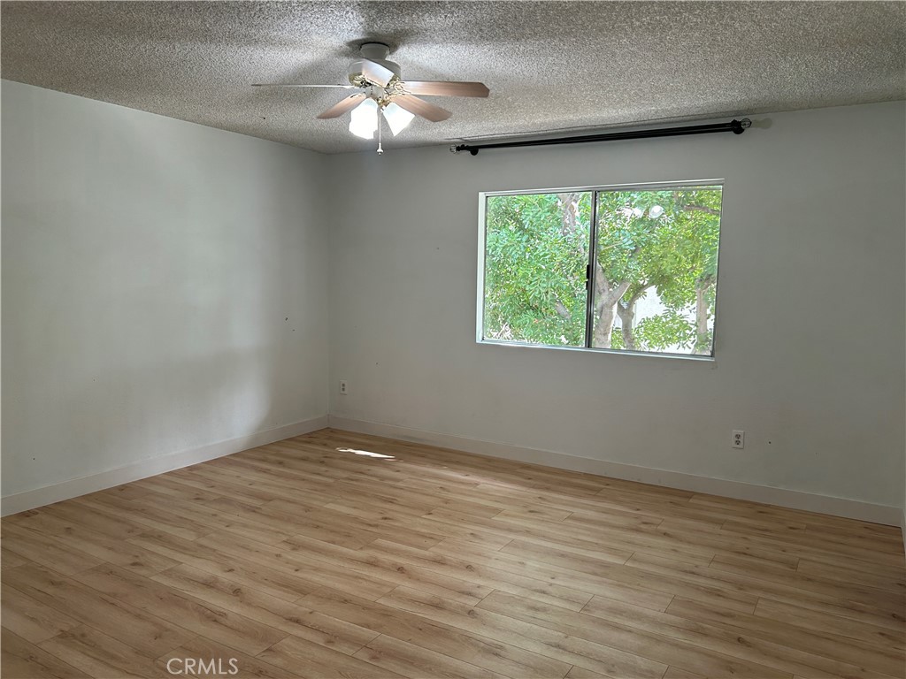 511 D Street Upland, CA 91786 - Photo 12 of 23 an empty room with wooden floor and windows