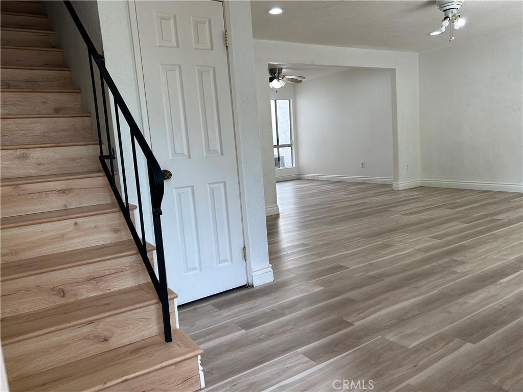 511 D Street Upland, CA 91786 - Photo 6 of 23 a view of a hallway with wooden floor and staircase