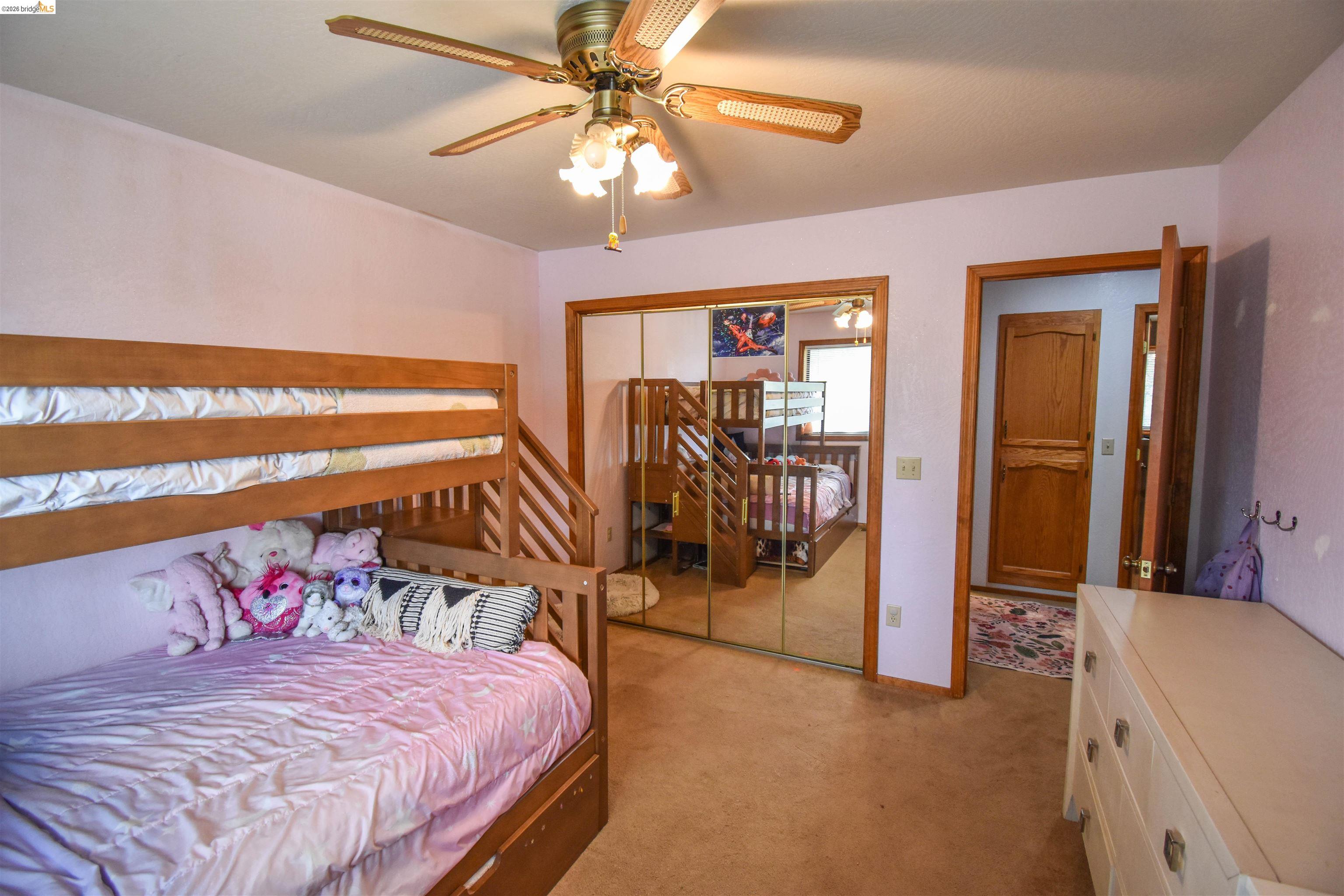 15 Roble Road Sonora, CA 95370 - Photo 23 of 44 Bedroom with a ceiling fan, light carpet, and a closet