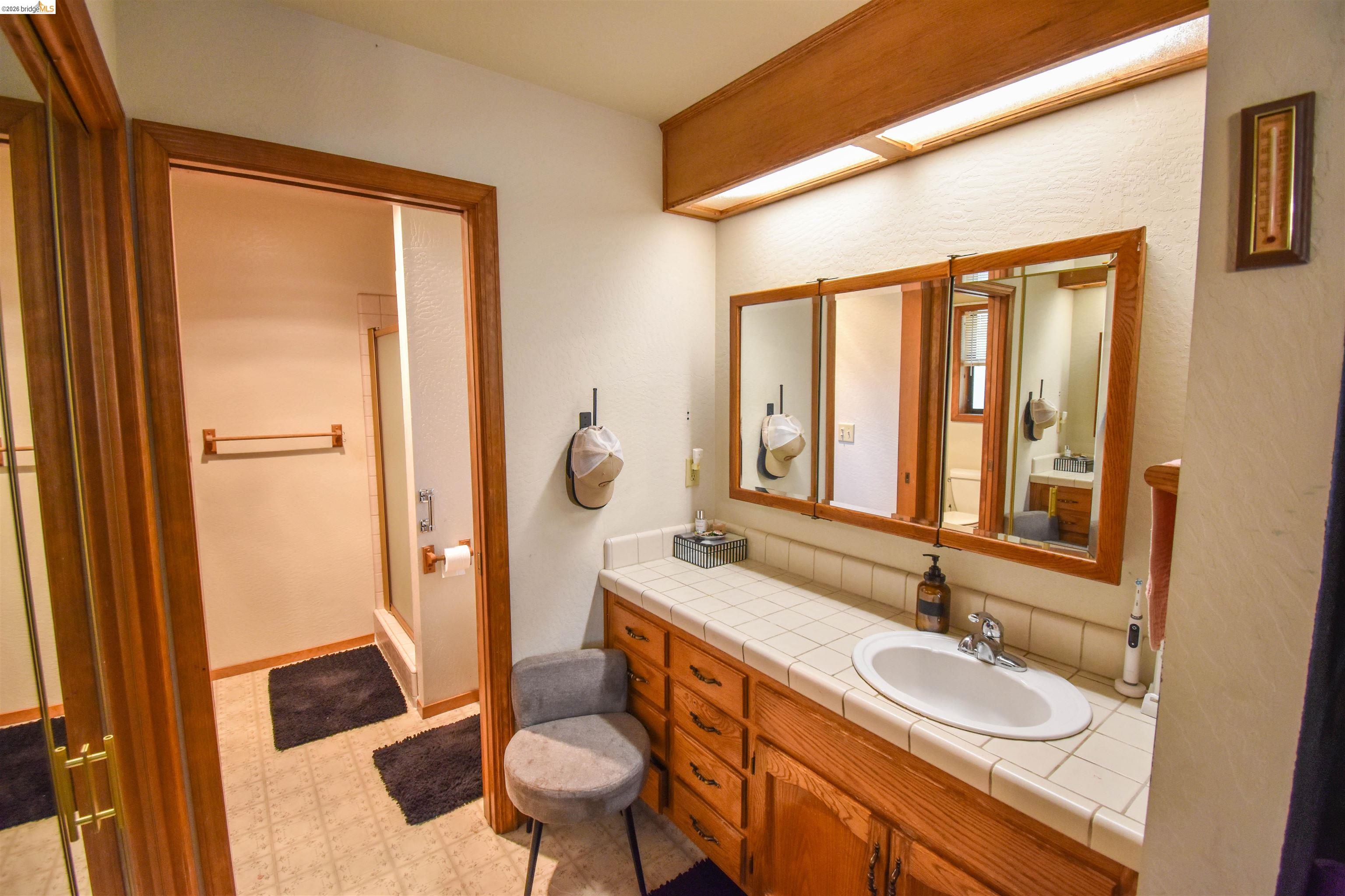 15 Roble Road Sonora, CA 95370 - Photo 26 of 44 Bathroom with vanity, light floors, and a stall shower