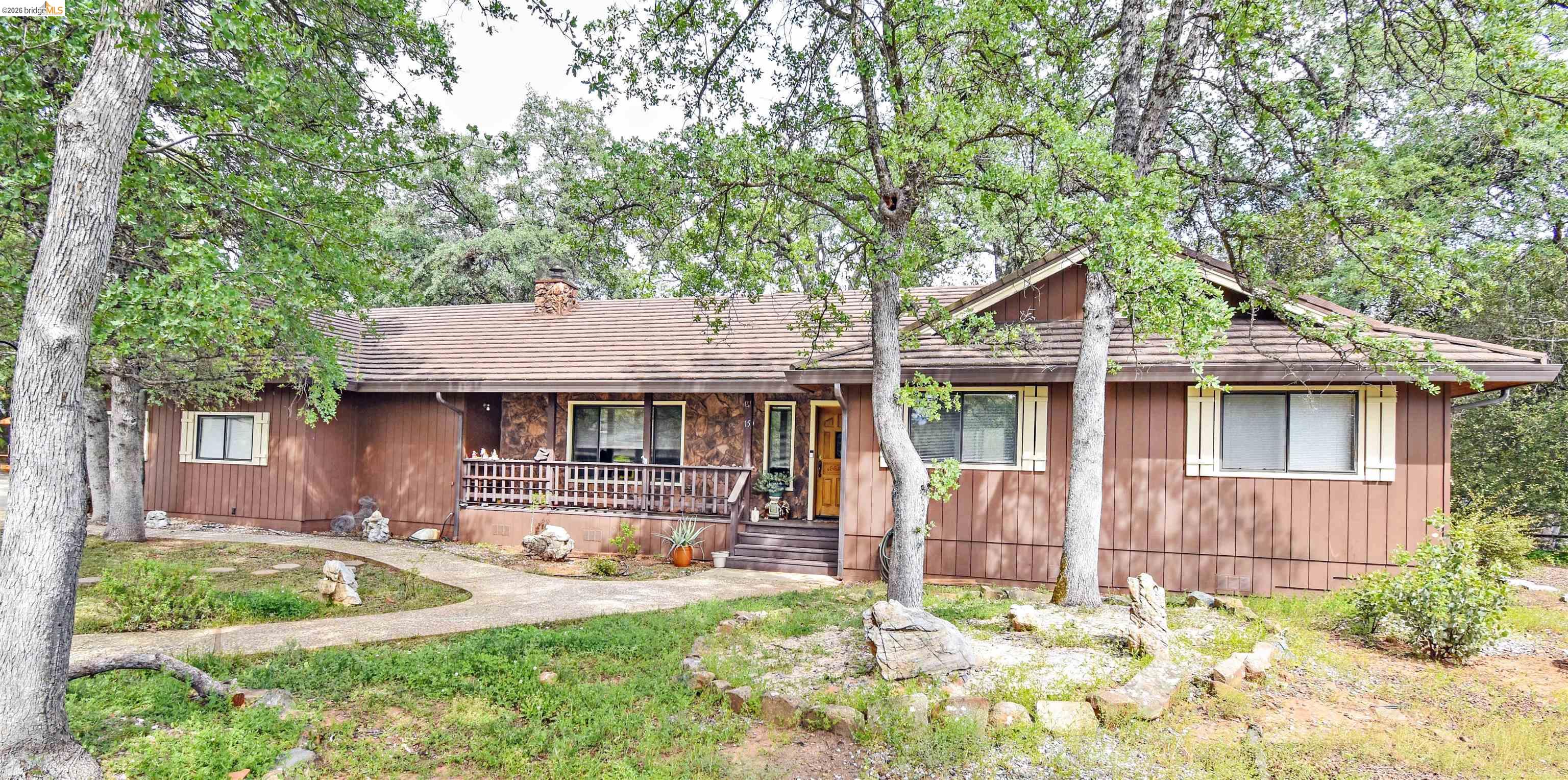 15 Roble Road Sonora, CA 95370 - Photo 3 of 44 View of front of home with a porch, a chimney, and stone siding