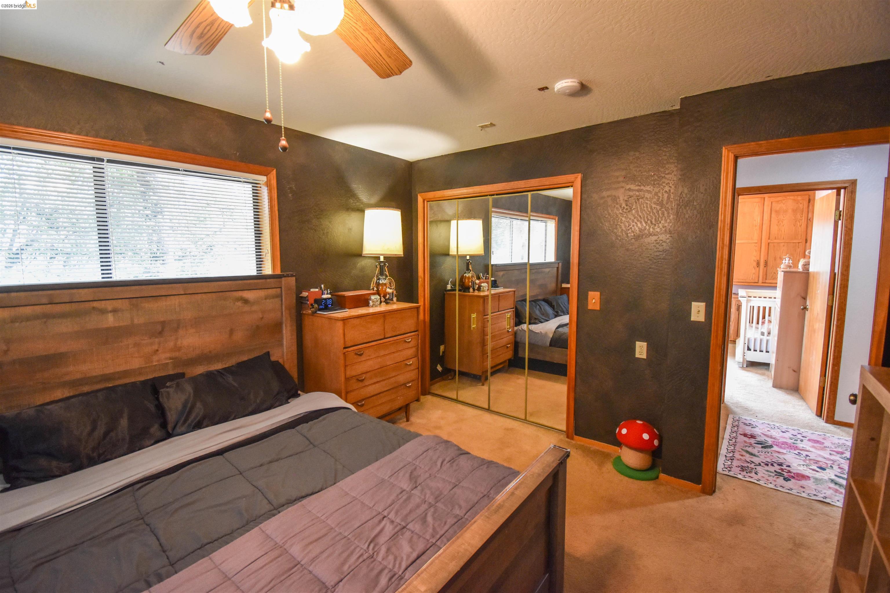 15 Roble Road Sonora, CA 95370 - Photo 32 of 44 Bedroom featuring a ceiling fan, light colored carpet, and a closet