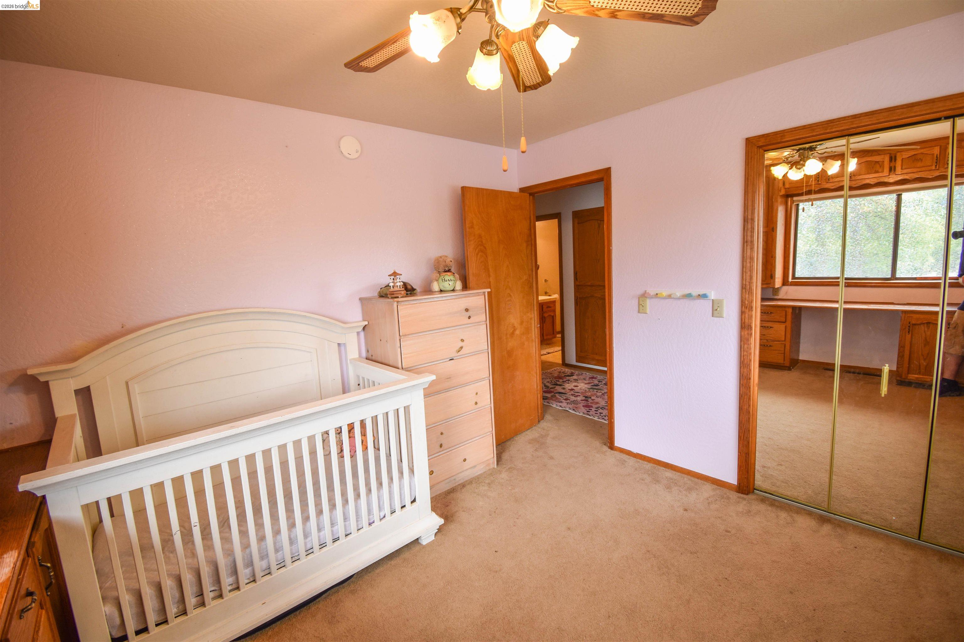 15 Roble Road Sonora, CA 95370 - Photo 34 of 44 Bedroom with light carpet, a closet, and a ceiling fan
